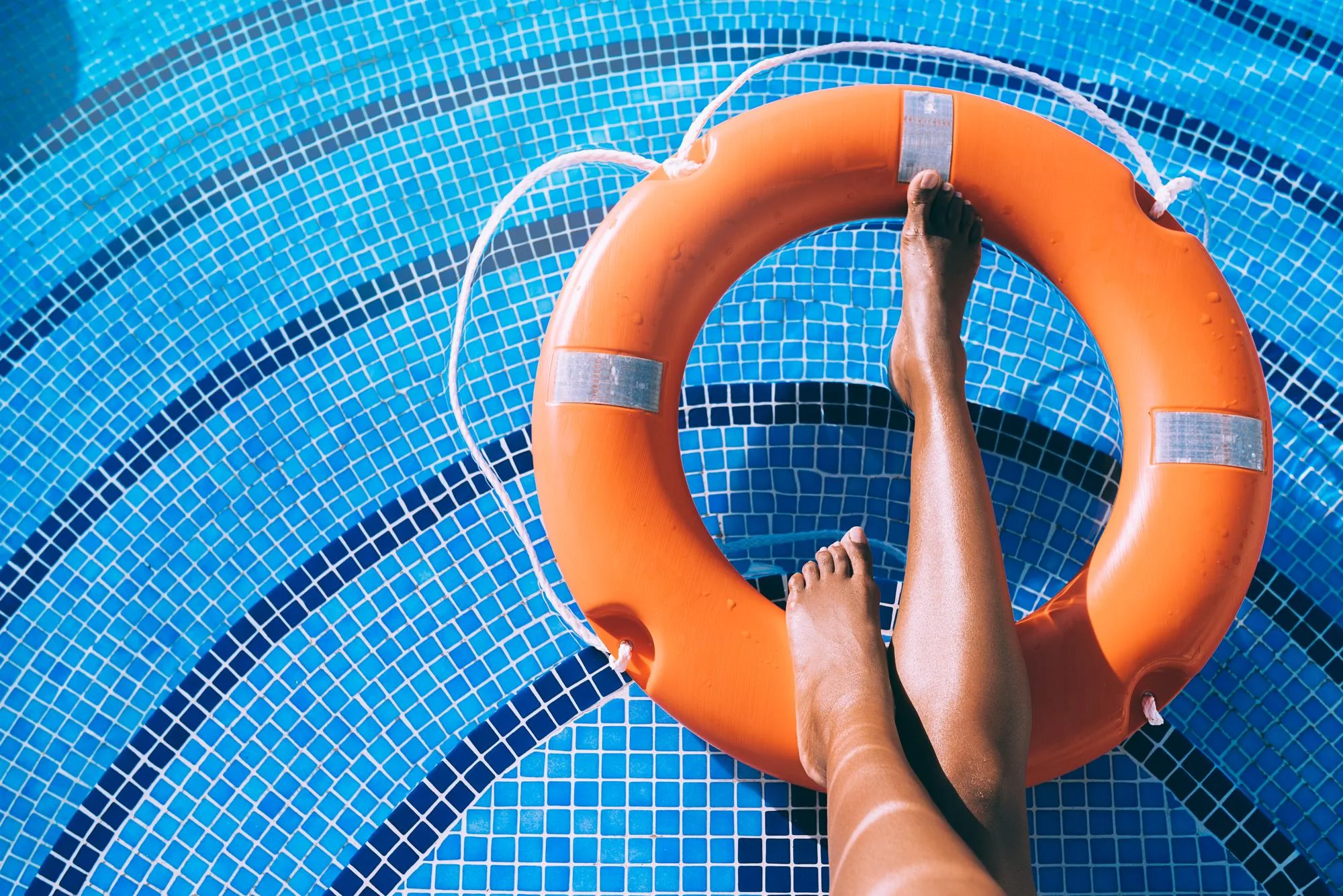 Orange lifebuoy in a pool